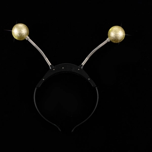 Detail of LED alien headband with spring antenna and gold glitter eyeballs for party