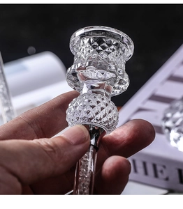 Macro detail of diamond cut glass candle holder with crushed crystal filling inside