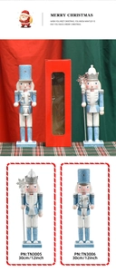 Details of two 30cm blue and white glitter wooden nutcrackers in festive gift packaging