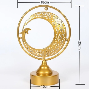 Detail of golden iron moon lamp with intricate cutout patterns and bird design