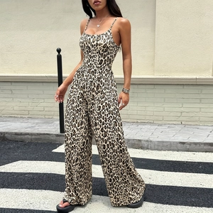 Detail of leopard print wide-leg jumpsuit with thin straps shown in outdoor street setting