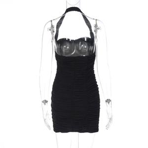 Detail of black halter bodycon dress showing textured pleats and slim fit tailoring