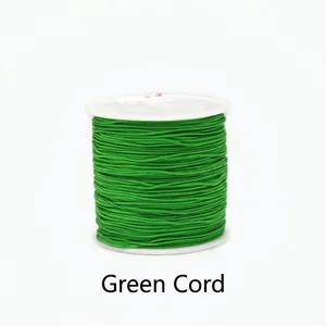 Detailed view of 0.8mm emerald green cord for handmade jewelry on a white plastic spool