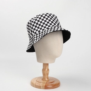 Fashionable black and white checkerboard bucket hat on a model for sun protection