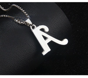 Macro view of the smooth silver stainless steel letter A pendant back with ball chain