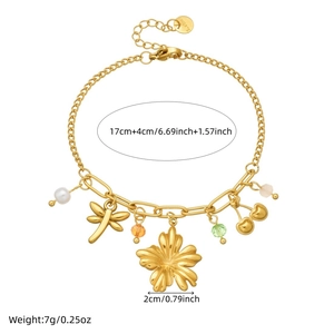 Pastel gold charm bracelet with pearls, dragonfly, and cherry blossoms on stainless steel chain