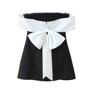 Elegant strapless black and white dress featuring a large bow and silk-like finish