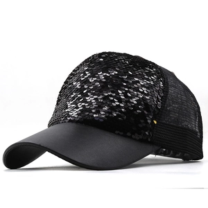 Detail of black sequined baseball cap showing reflective sequins and breathable mesh back