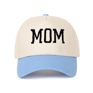 Close-up of retro MOM embroidery on beige and sky blue contrast trucker hat