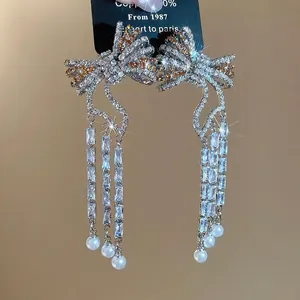 Sparkling zircon bow earrings with long tassel and pearls in a luxury vintage design
