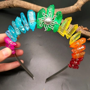 Detailed view of rainbow crystal headband with silver sun charm and wire wrapping