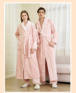 Detail of pink flannel bathrobe set featuring soft plush fabric and white contrast piping