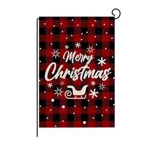 Detail of linen Christmas garden flag with Merry Christmas text and red plaid pattern