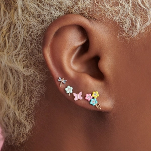 Macro detail of S925 silver enamel earrings featuring dragonfly, floral and butterfly shapes