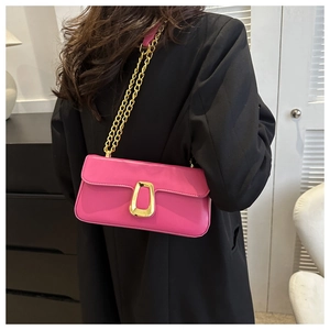 Detail of rose red PU leather shoulder bag with gold chain strap and horseshoe buckle