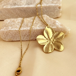 Elegant gold flower pendant necklace with textured petals on minimalist titanium steel chain