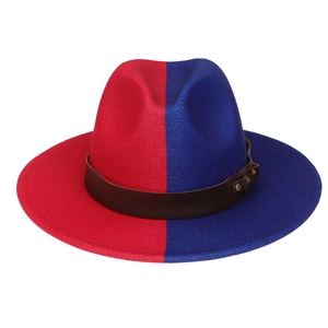 Close-up of red and blue wool felt jazz hat with a brown leather band and metal studs