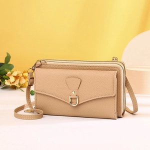 Detail of apricot crossbody phone bag with triple zippers and lychee texture leather