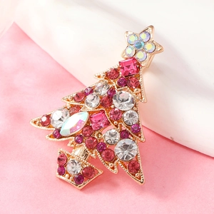 Close-up of rose gold Christmas tree brooch with colorful rhinestones and crystal star
