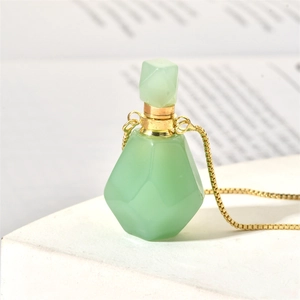 Close-up of green aventurine flame-shaped perfume bottle pendant with gold chain