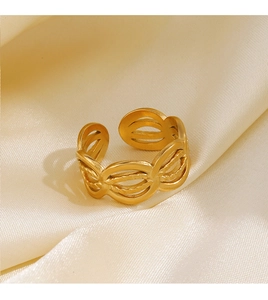 Close-up of golden interlocking oval rings on elegant beige satin fabric texture