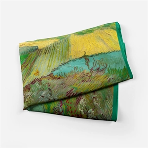 Detailed view of folded silk scarf featuring Van Gogh oil painting wheat field patterns