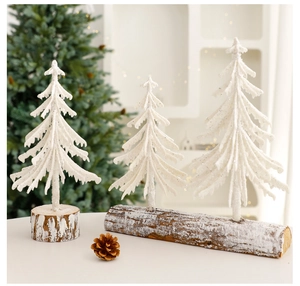 Miniature white frosted Christmas trees with wooden bases and glittery snow texture