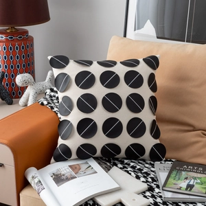 Detail of luxury cream cushion with black geometric patterns on a modern sofa set