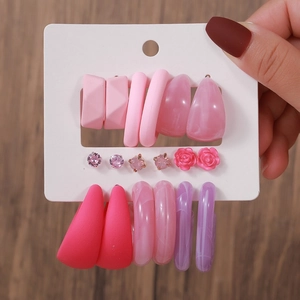 Close-up of pink heart and imitation pearl stud earring set on display card