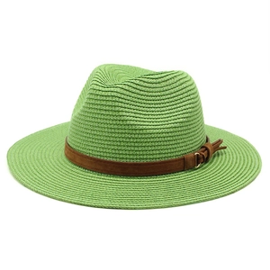 Detailed view of lime green straw sun hat with brown suede band and gold buckle