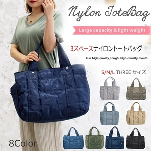 Quilted nylon tote bag detail with three separate compartments for organized storage