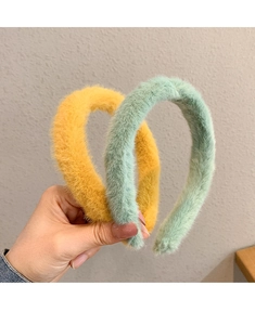 Close-up of soft yellow and green plush headbands with anti-slip texture