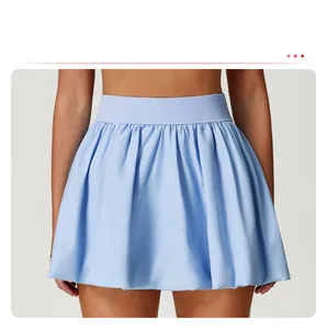 Detail of light blue tennis skirt featuring a high-waisted bubble hem with pleated texture