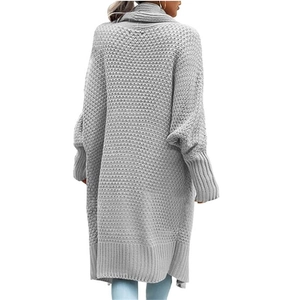 Detailed view of grey long-line cardigan featuring thick textured knit and batwing sleeves
