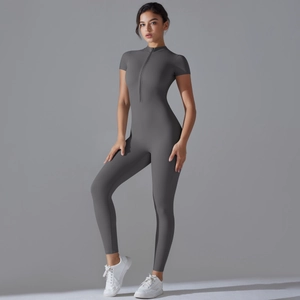 Close-up of the front zipper and stand collar on the dark grey yoga jumpsuit