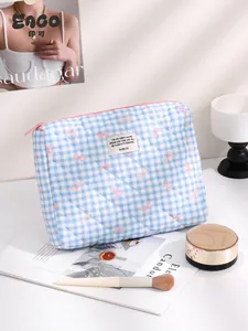 Blue gingham quilted cosmetic bag with pink bow prints and portable top handle