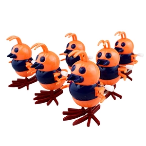 Detailed view of six colorful clockwork chick toys with mechanical winding keys on white background