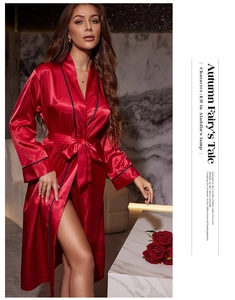 Close-up of luxurious red satin robe with contrast black piping and silky texture