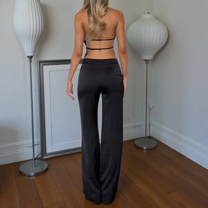 Chic backless halter top and satin wide-leg trousers set in black for a slim fit