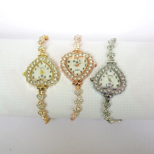 Detailed view of heart-shaped quartz watches in gold, rose gold, and silver finishes