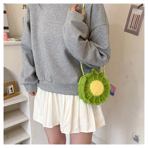 Detail of a handmade sunflower crochet crossbody bag in vibrant green and yellow cotton