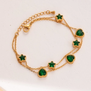 Gold double-layer bracelet featuring emerald green star and heart shaped stones