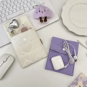 Detailed view of quilted heart pattern and snap closure on soft mini storage pouches