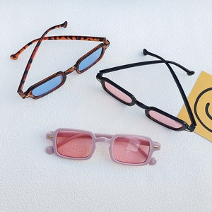 Detailed flat lay of retro rectangular sunglasses with rivets in assorted color frames