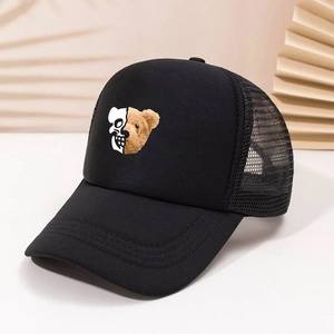 Detail of black trucker hat featuring unique skull and bear head patchwork print design