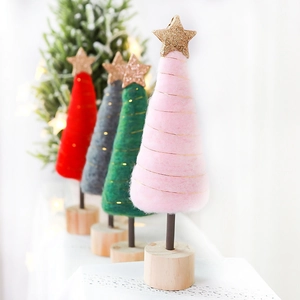 Pink and green felt wool mini Christmas trees with gold stars on a wooden base