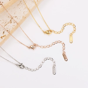 Three minimalist 18KGP butterfly necklaces in gold, rose gold, and silver finishes