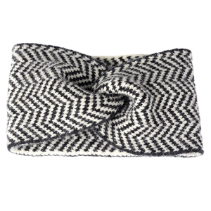 Winter knitted headband featuring black and white zigzag pattern and a twist knot design