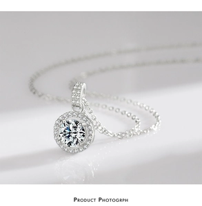 Macro shot of silver sterling halo necklace with sparkling round cubic zirconia stones