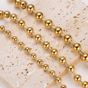 Elegant gold stainless steel bead chain bracelet shown on a textured stone surface